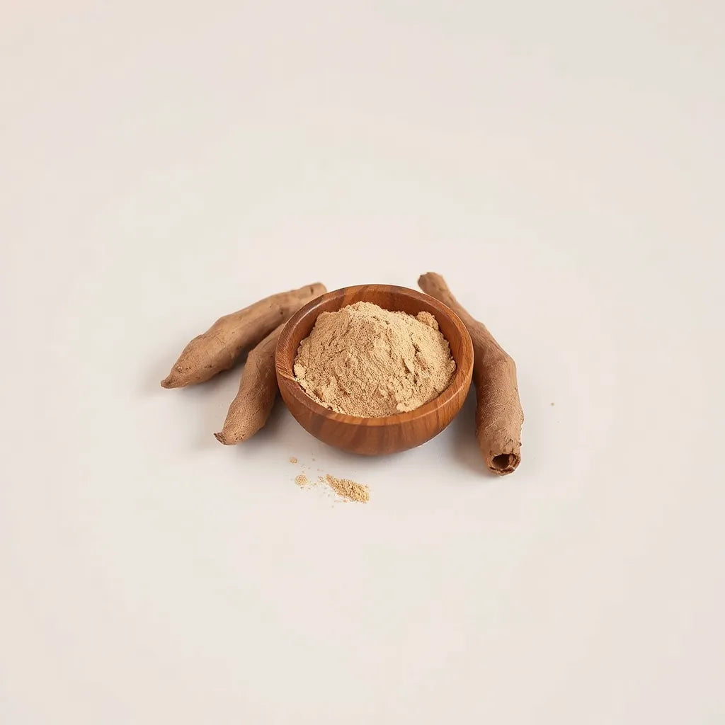 Maca roots and maca powder in a wooden bowl on a clean light background
